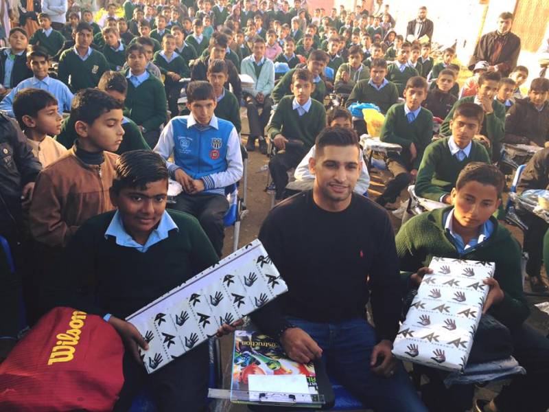 Amir Khan distributes PCs in Mirpur schools