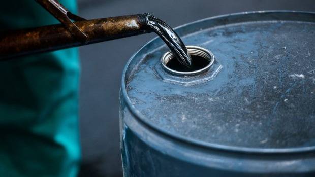 Oil edges up on increased US stockpile