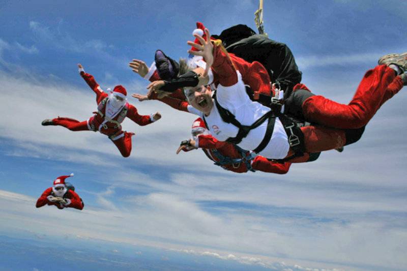 Officially amazing: 155 sky-diving Santas set new world record for most tandem flights