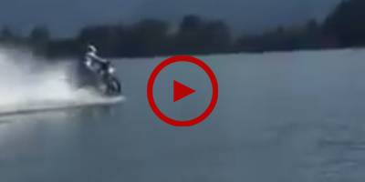 Daredevil rides motorcycle on the ocean
