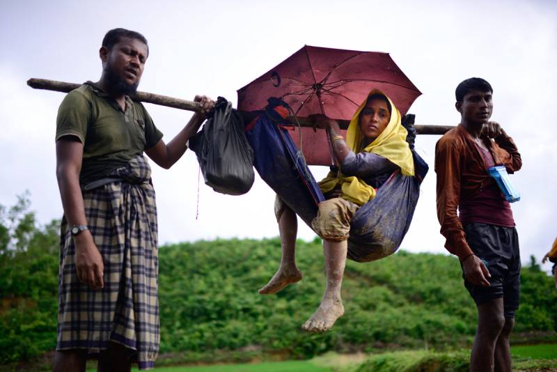 Visuals of an aged, sick woman fleeing Myanmar on foot shock social media