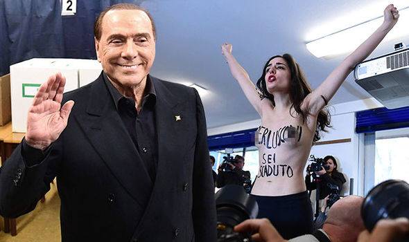 Topless Femen protester confronts former Italian PM Berlusconi at polling station (VIDEO)
