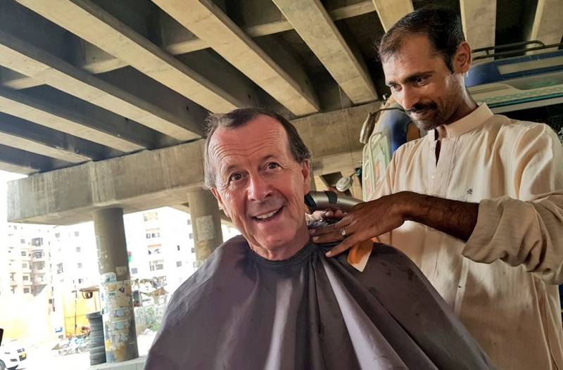 German ambassador gets haircut from roadside barber in Karachi