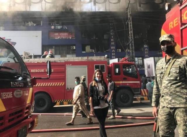 Why is this girl smiling outside the burning Hafeez Centre?