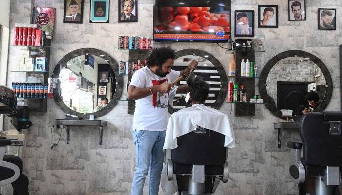 Pakistani barber offers haircuts with cleavers and blowtorches