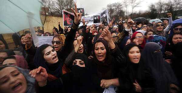 Afghan women chant slogans during a protest demanding justice for a woman who was beaten to death by a mob after being falsely accused of burning a Quran last week, in downtown Kabul, Afghanistan, Tuesday, March 24, 2015. Men and women of all ages carried banners bearing the bloodied face of Farkhunda, a 27-year-old religious scholar killed last week by a mob. Farkhunda, who went by one name like many Afghans, was beaten, run over with a car and burned before her body was thrown into the Kabul River. (AP Photo/Rahmat Gul)