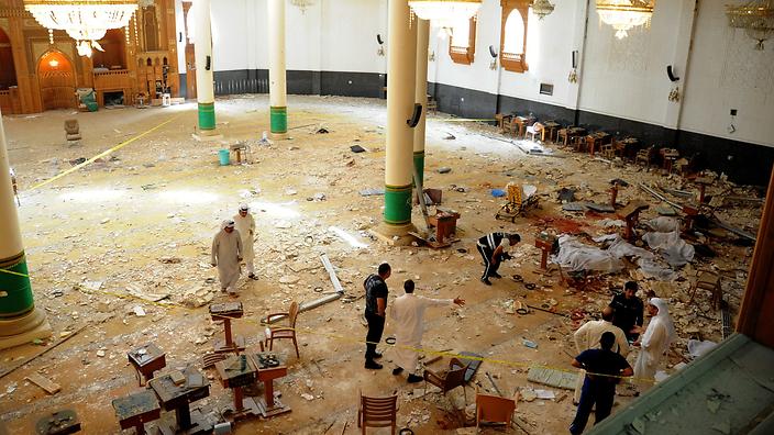epaselect epa04820003 Medics and security forces gather inside Imam Sadiq Mosque following a suicide bombing in al-Sawaber, Kuwait City, Kuwait, 26 June 2015. Media reports said 24 people were killed and 25 wounded in a suicide bombing at a Shiite mosque in Kuwait where worshippers had gathered for Friday prayers during the holy month of Ramadan. The Islamic State extremist group claimed responsibility for the attack, according to a statement circulated on social media which could not be immediately verified. EPA/RAED QUTENA