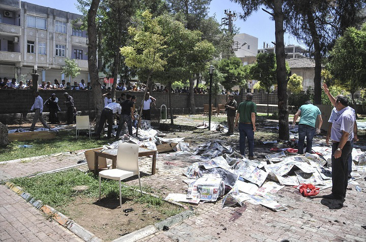 SANLIURFA, TURKEY - JULY 20: People gather at the site of an explosion in Suruc district of Sanliurfa, Turkey on July 20, 2015. Casualties reported after an explosion in southeastern Turkish province of Sanliurfa bordering Syria. (Photo by Rauf Maltas/Anadolu Agency/Getty Images)