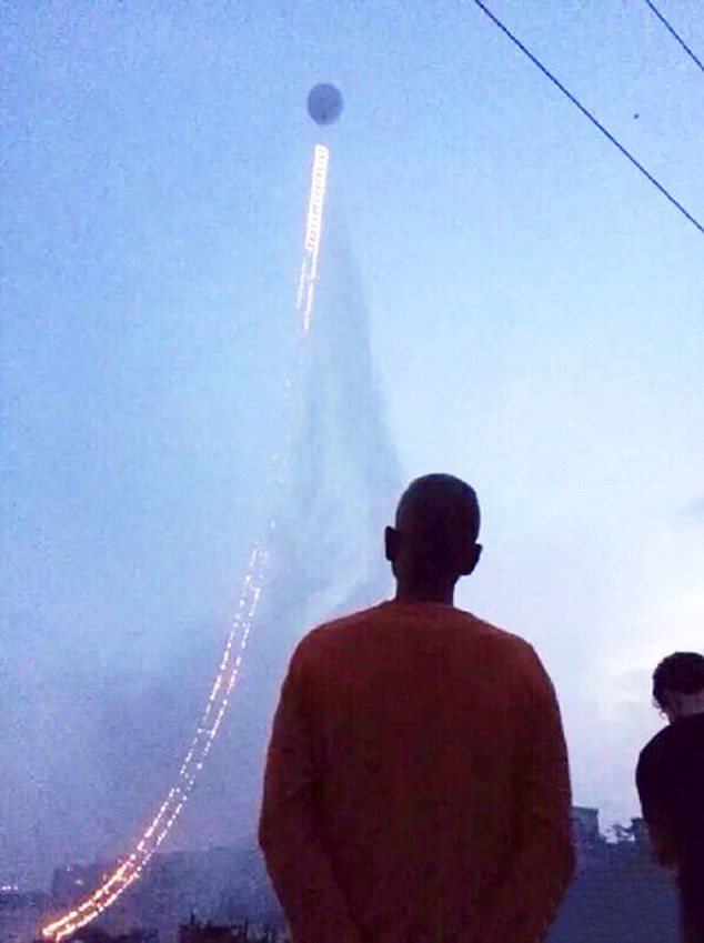 Pic shows: The firework display fullfiled by a Chinese artist in the shape of a ladder that extends up into the sky. A well-known Chinese artist and pyrotechnic enthusiast this week fulfilled his decades-old dream of creating a firework display in the shape of a ladder that extends up into the sky. Cai Guoqiang, a native Quanzhou City of south-east Chinas Fujian Province, put on display the art piece known as the 
