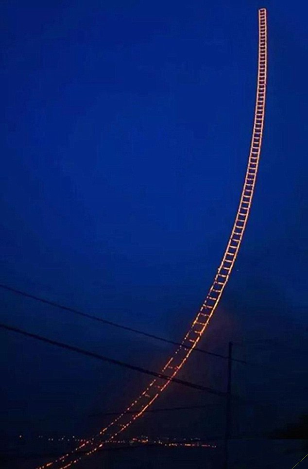 Pic shows: The firework display fullfiled by a Chinese artist in the shape of a ladder that extends up into the sky. A well-known Chinese artist and pyrotechnic enthusiast this week fulfilled his decades-old dream of creating a firework display in the shape of a ladder that extends up into the sky. Cai Guoqiang, a native Quanzhou City of south-east China’s Fujian Province, put on display the art piece known as the 
