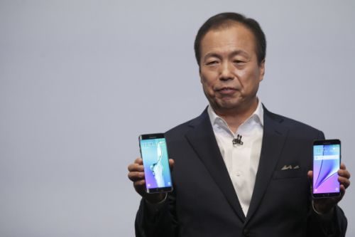 JK Shin, president and CEO of Samsung Electronics, holds the Samsung Galaxy S6 Edge Plus, left, and the Samsung Galaxy Note 5 during a presentation, Thursday, Aug. 13, 2015, at Lincoln Center in New York. (AP Photo/Mary Altaffer)