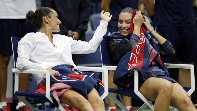 Roberta Vinci, of Italy, left, talks with Flavia Pennetta, of Italy, after Pennetta beat Vinci in the women's championship match of the U.S. Open tennis tournament, Saturday, Sept. 12, 2015, in New York. (AP Photo/David Goldman)