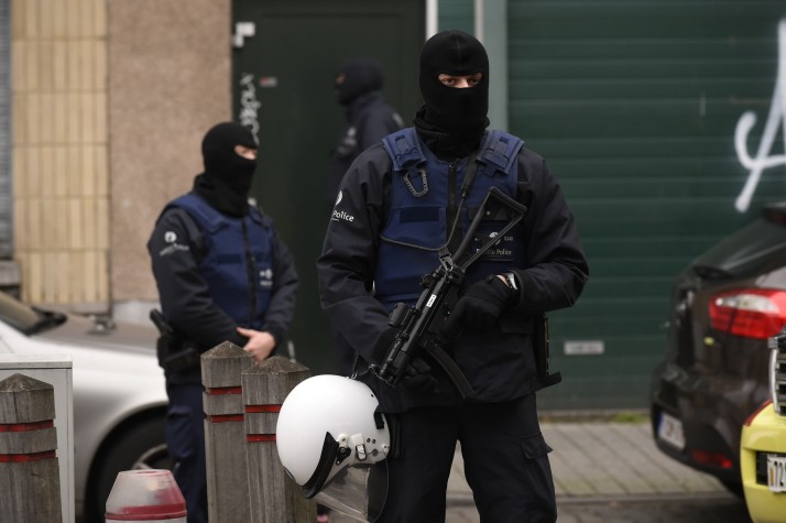 Police officers stand guard as an operation takes place in the Molenbeek district of Brussels on November 16, 2015. Belgian police launched a major new operation in the Brussels district of Molenbeek, where several suspects in the Paris attacks had previously lived, AFP journalists said. Armed police stood in front of a police van blocking a street in the run-down area of the capital while Belgian media said officers had surrounded a house. Belgian prosecutors had no immediate comment. AFP PHOTO / JOHN THYS (Photo credit should read JOHN THYS/AFP/Getty Images)