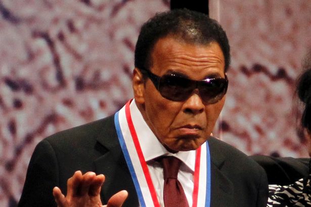 Boxing great Muhammad Ali waves after being awarded the Liberty Medal at the National Constitution Center in Philadelphia, Pennsylvania