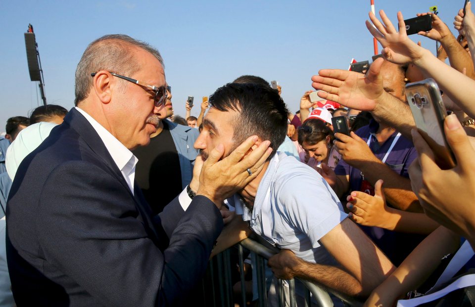 Turkey's President Tayyip Erdogan holds a head of the man as he attends the Democracy and Martyrs Rally, organized by him and supported by ruling AK Party (AKP), oppositions Republican People's Party (CHP) and Nationalist Movement Party (MHP), to protest against last month's failed military coup attempt, in Istanbul, Turkey, August 7, 2016. Kayhan Ozer/Presidential Palace/Handout via REUTERS FOR EDITORIAL USE ONLY. NOT FOR SALE FOR MARKETING OR ADVERTISING CAMPAIGNS. THIS IMAGE HAS BEEN SUPPLIED BY A THIRD PARTY. IT IS DISTRIBUTED, EXACTLY AS RECEIVED BY REUTERS, AS A SERVICE TO CLIENTS.