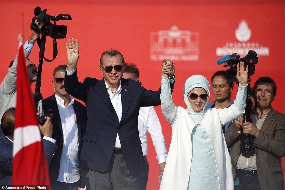 Turkish President Recep Tayyip Erdogan, left, and his wife Emine wave to the crowd during a Democracy and Martyrs' Rally in Istanbul, Sunday, Aug. 7, 2016. A massive crowd of flag-waving supporters gathered in Istanbul Sunday for a giant rally to mark the end of nightly demonstrations since Turkeys July 15 abortive coup that left more than 270 people dead. (AP Photo/Emrah Gurel)