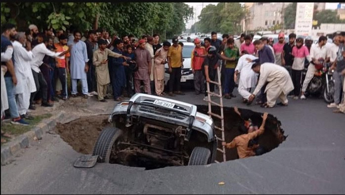 Massive Sinkhole In Lahore Swallows Three Vehicles Causes Major Traffic Disruptions