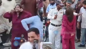 Watch Karachi Woman Blocks Traffic Damages Vehicles After Car Rickshaw Collision